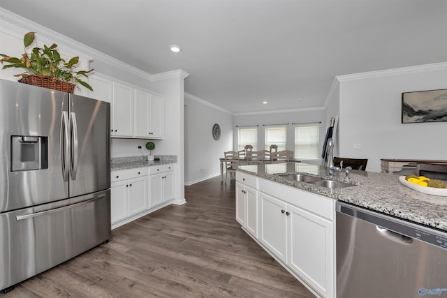 kitchen with appliances with stainless steel finishes, light stone countertops, and dark wood-type flooring