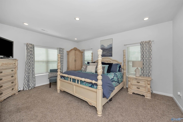 carpeted bedroom featuring multiple windows