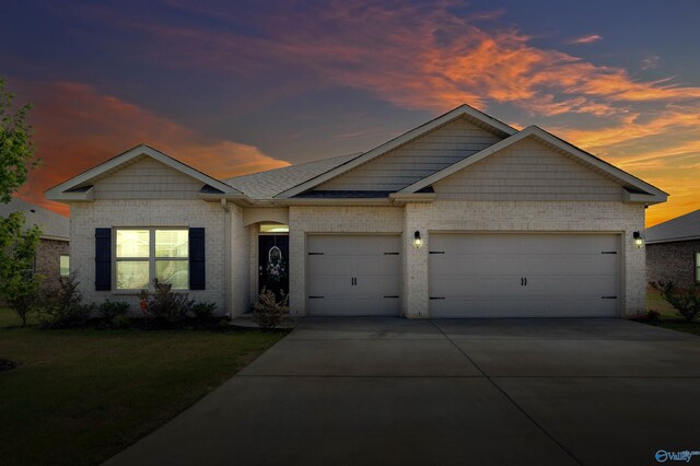 view of front of home featuring a garage and a front yard