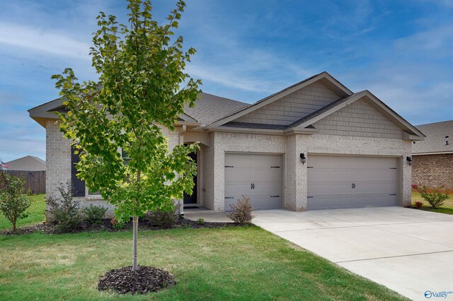 view of front of home with a front yard and a garage