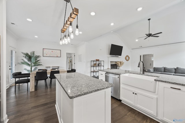 kitchen featuring sink, white cabinets, hanging light fixtures, a center island, and stainless steel dishwasher