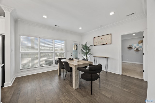 dining area featuring ornamental molding and dark hardwood / wood-style flooring