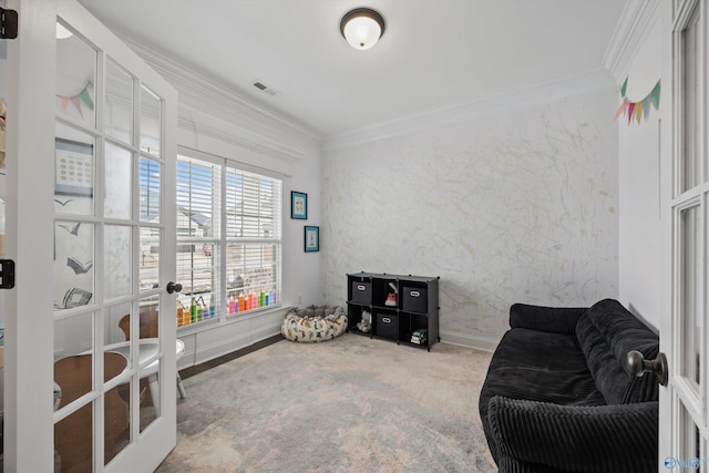 sitting room featuring crown molding, carpet floors, and french doors