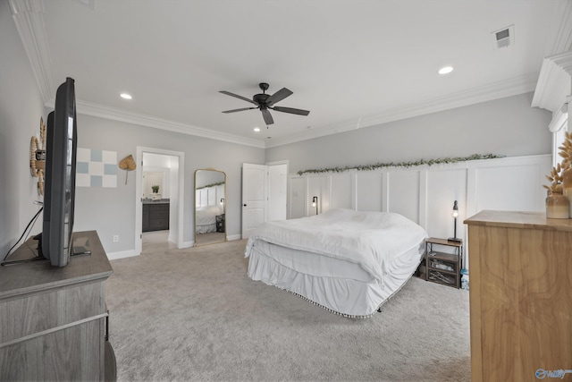 bedroom featuring crown molding, connected bathroom, light carpet, and ceiling fan