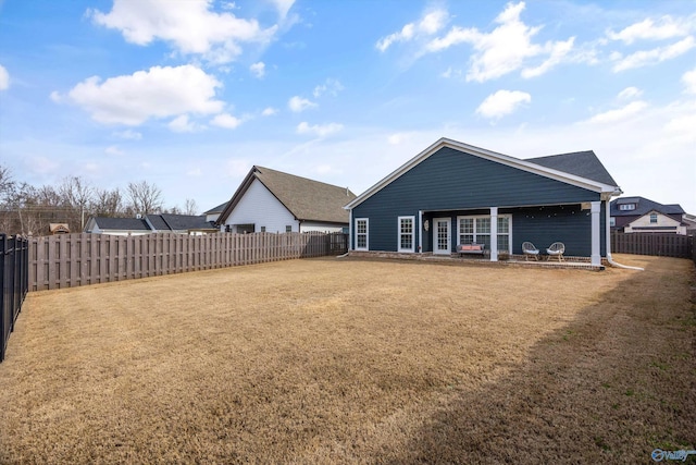 rear view of property with a lawn