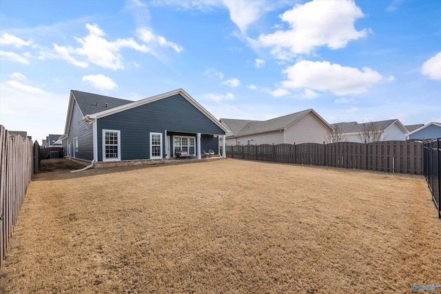 back of house featuring a yard