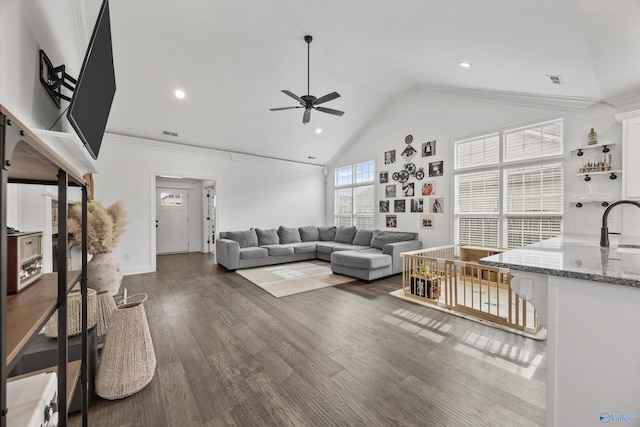 living room with dark hardwood / wood-style floors, high vaulted ceiling, sink, ceiling fan, and crown molding