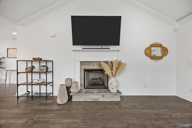 living room with lofted ceiling, ornamental molding, dark hardwood / wood-style flooring, and a stone fireplace