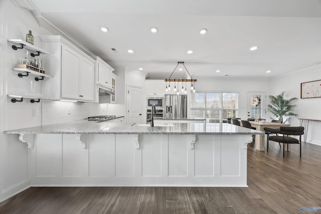 kitchen with sink, white cabinetry, light stone counters, kitchen peninsula, and stainless steel appliances