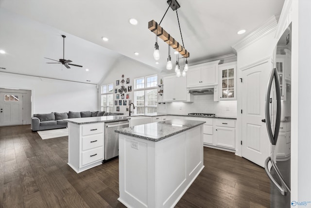 kitchen with white cabinetry, stainless steel appliances, a kitchen island, and pendant lighting