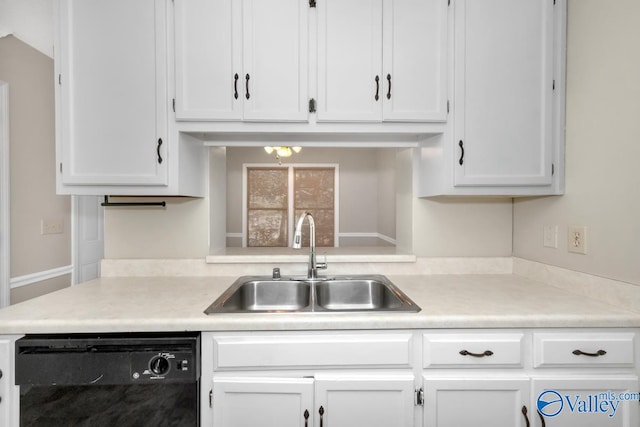 kitchen featuring black dishwasher, sink, and white cabinets