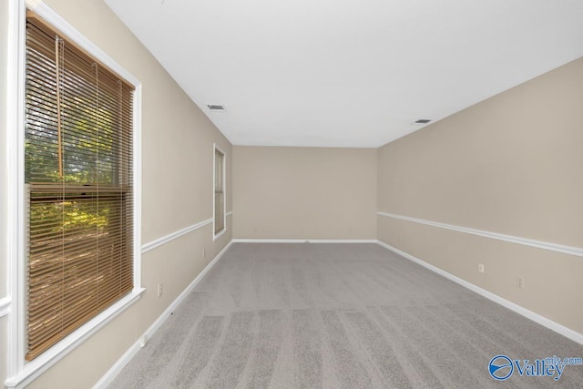 unfurnished room featuring light colored carpet