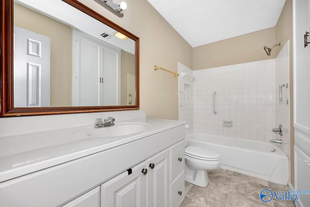 full bathroom with toilet, tiled shower / bath, and vanity