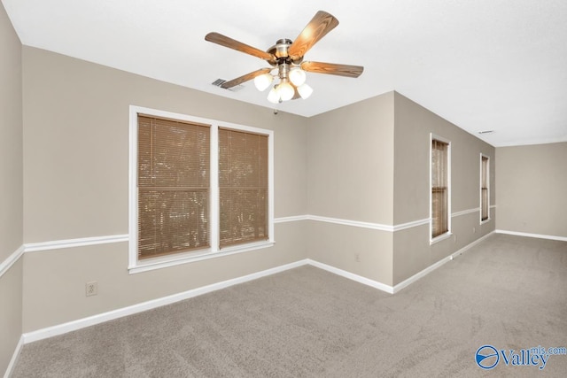 carpeted spare room with ceiling fan