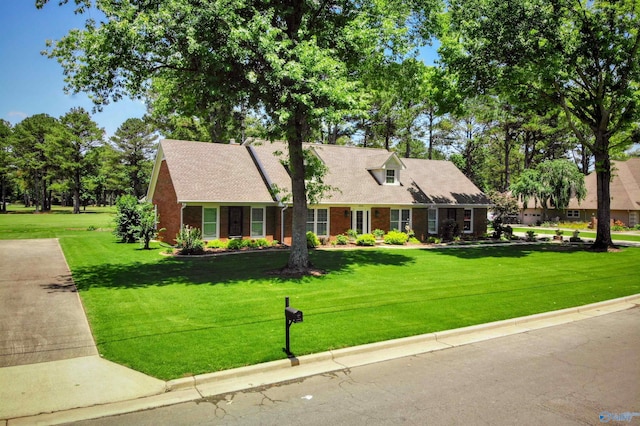 cape cod-style house with a front yard