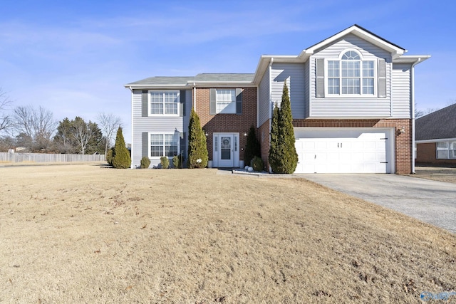 view of front of house with a garage and a front yard