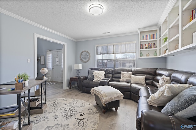 living room featuring crown molding, a textured ceiling, and light wood-type flooring