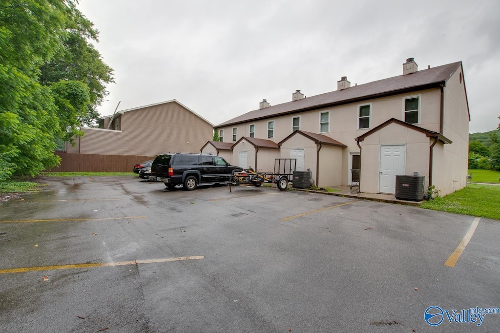 2613 Wynterhall Rd, Huntsville, AL 35803 - back of property featuring a chimney, uncovered parking, and central air condition unit