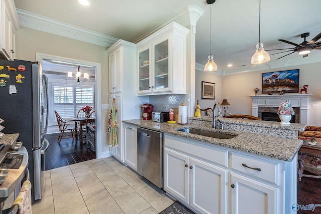 kitchen featuring white cabinets, appliances with stainless steel finishes, sink, and crown molding