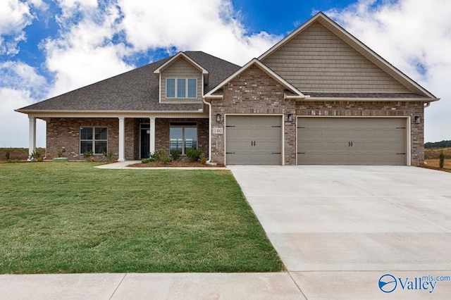 craftsman-style house with a front yard and a garage