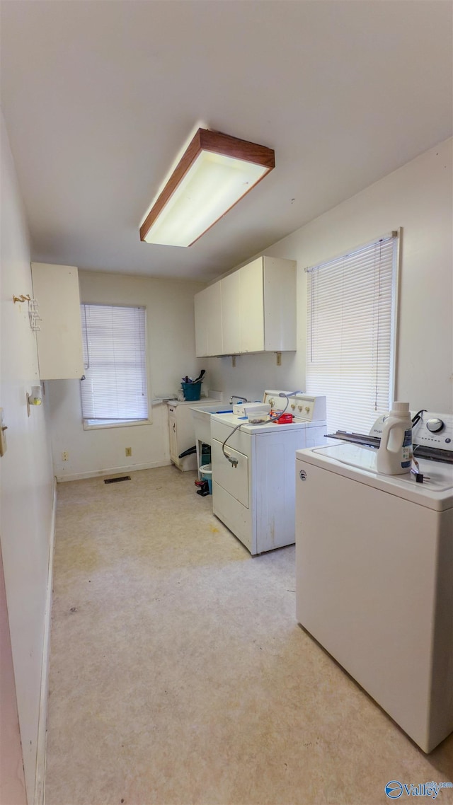 2808 Elmore Rd, Huntsville, AL 35805 - washroom featuring cabinet space, washer and dryer, light colored carpet, and baseboards