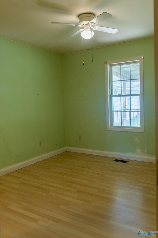 2808 Elmore Rd, Huntsville, AL 35805 - empty room with light wood-style flooring, a ceiling fan, and baseboards