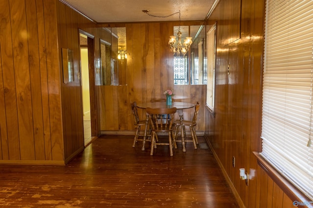 2808 Elmore Rd, Huntsville, AL 35805 - dining space with wood walls, hardwood / wood-style floors, a chandelier, baseboards, and crown molding