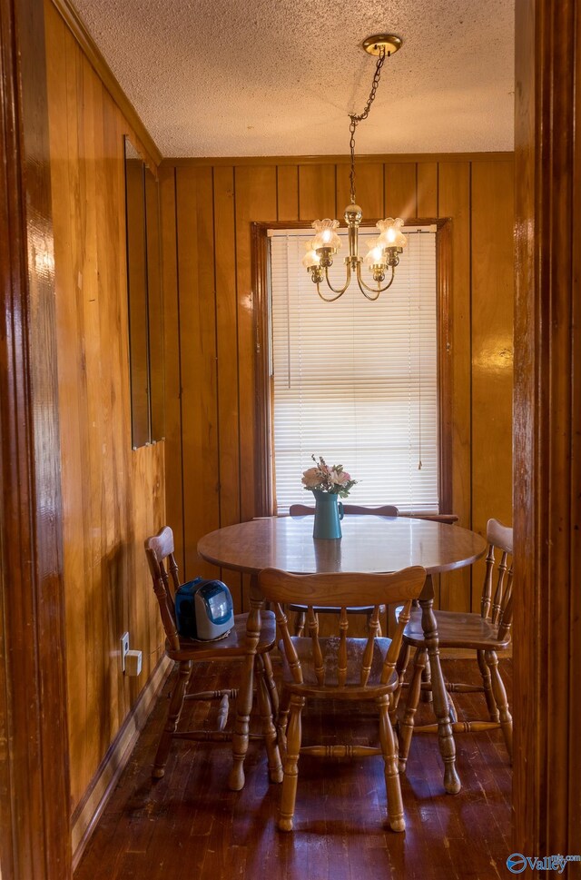2808 Elmore Rd, Huntsville, AL 35805 - dining space with a textured ceiling, wood-type flooring, a chandelier, and wooden walls