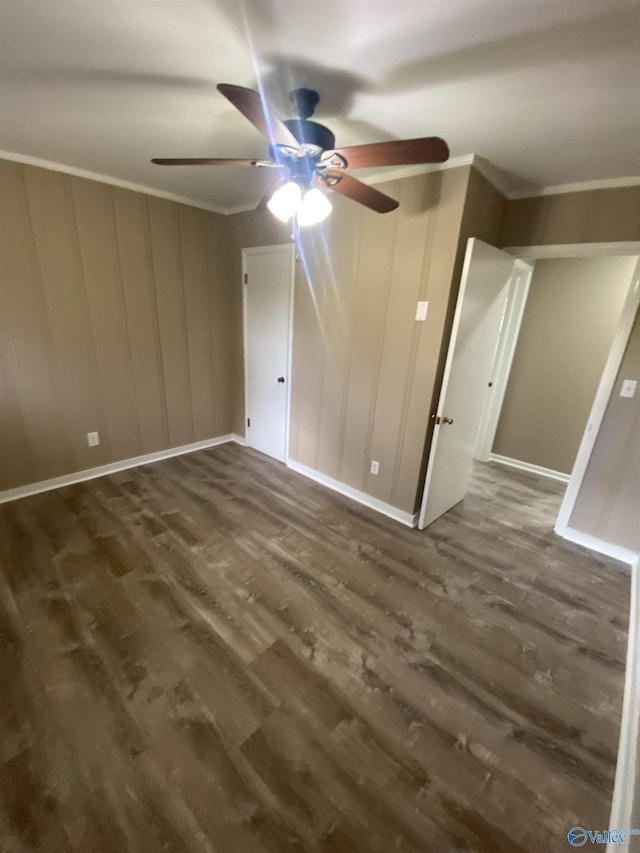 empty room with ornamental molding and dark wood-type flooring