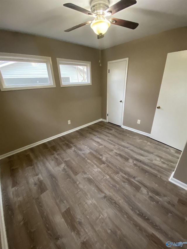 unfurnished bedroom featuring dark hardwood / wood-style flooring and ceiling fan