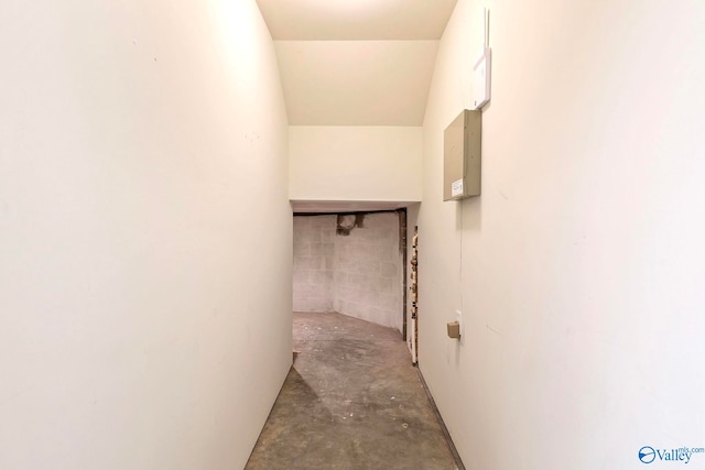 corridor with electric panel and concrete flooring