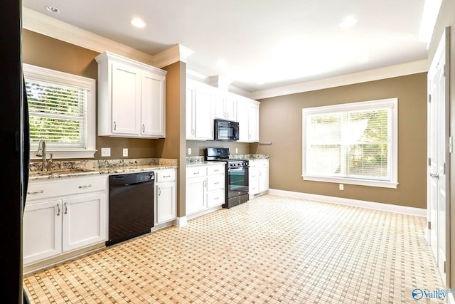 kitchen featuring sink, black appliances, white cabinets, and plenty of natural light