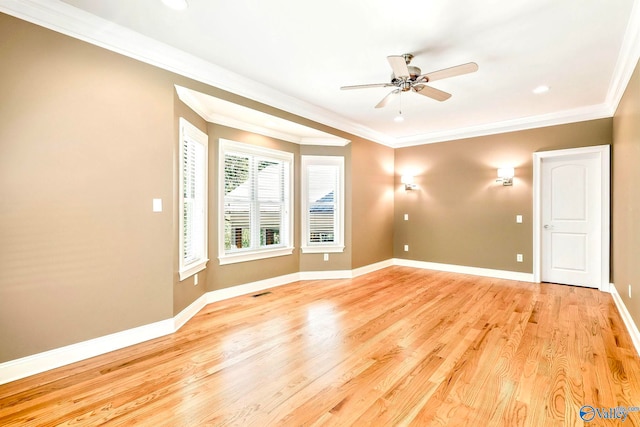 empty room featuring ornamental molding, light wood-type flooring, and ceiling fan