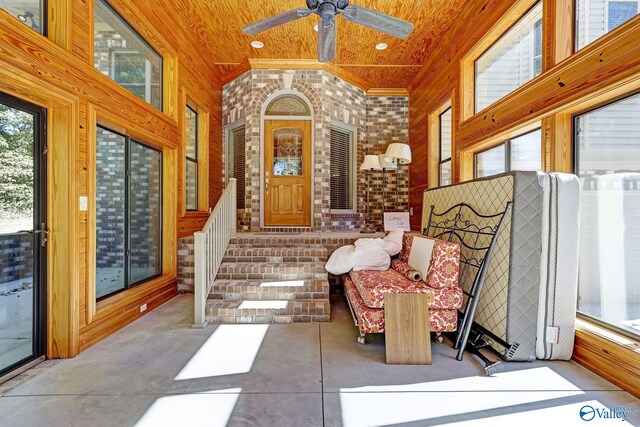 sunroom / solarium featuring wood ceiling and ceiling fan