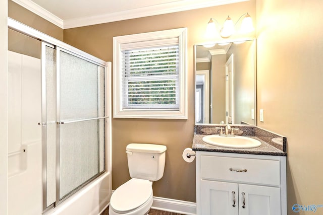 full bathroom featuring toilet, combined bath / shower with glass door, vanity, and crown molding