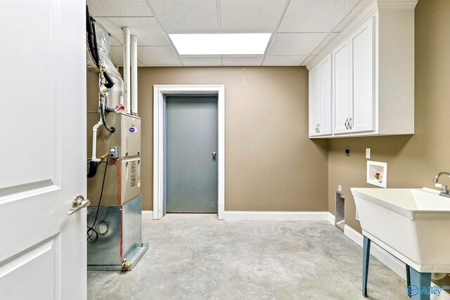 laundry area featuring sink, electric dryer hookup, washer hookup, and cabinets