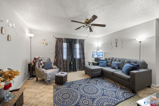 living room featuring light colored carpet, a textured ceiling, and ceiling fan