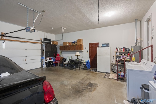 garage featuring separate washer and dryer, a garage door opener, water heater, and white fridge