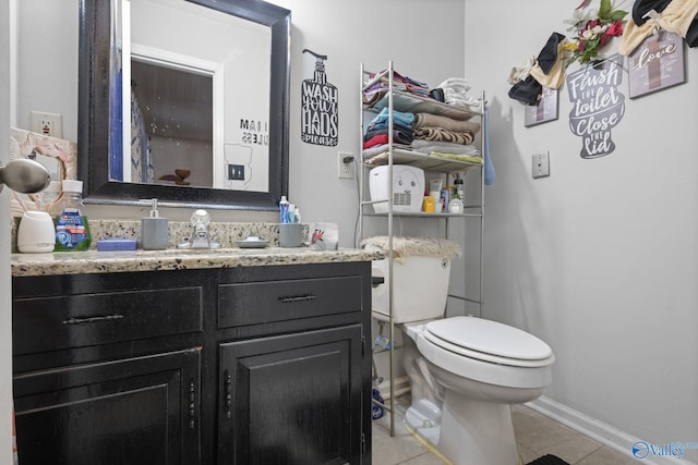 bathroom featuring vanity, tile patterned flooring, and toilet