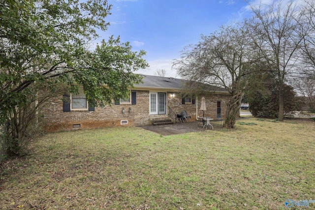 back of property featuring a lawn and a patio