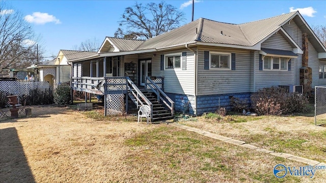 bungalow-style home featuring a front yard