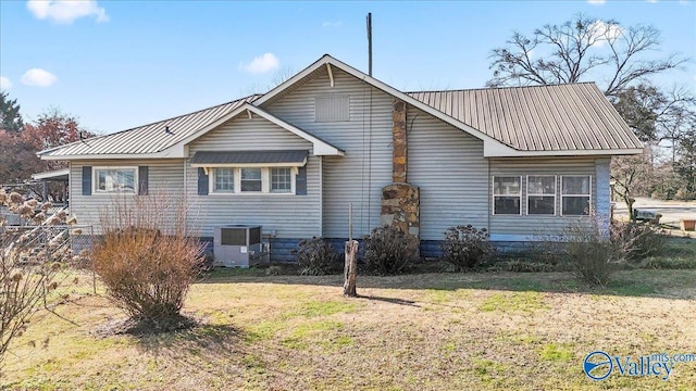 view of side of home featuring a yard and central AC