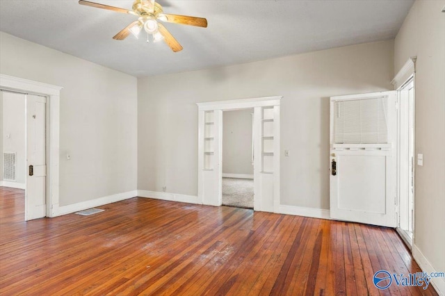 unfurnished bedroom with dark wood-type flooring and ceiling fan