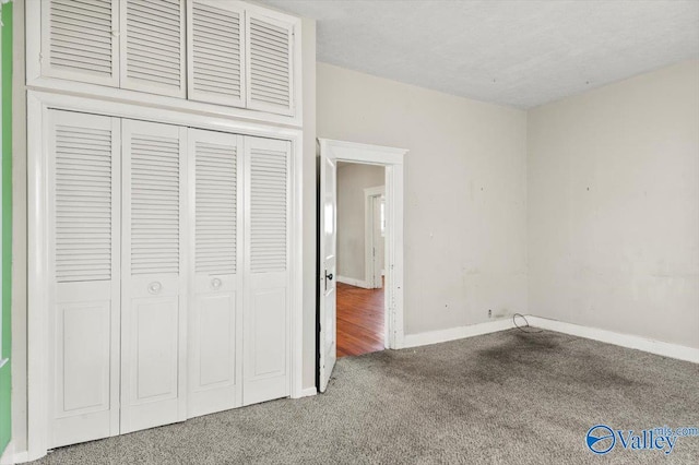 unfurnished bedroom with carpet and a closet