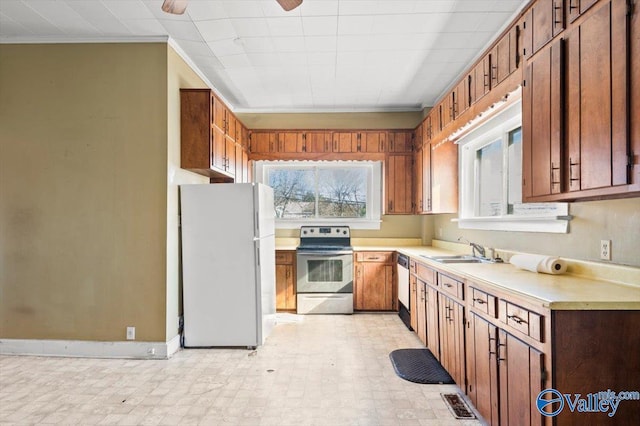 kitchen with ceiling fan, ornamental molding, appliances with stainless steel finishes, and sink