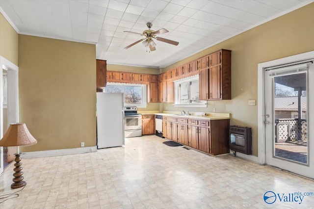 kitchen featuring heating unit, dishwasher, fridge, a healthy amount of sunlight, and stainless steel electric range