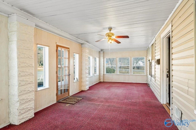 unfurnished sunroom with ceiling fan and a healthy amount of sunlight