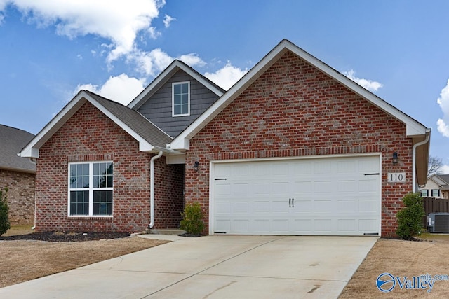 front of property featuring central air condition unit and a garage