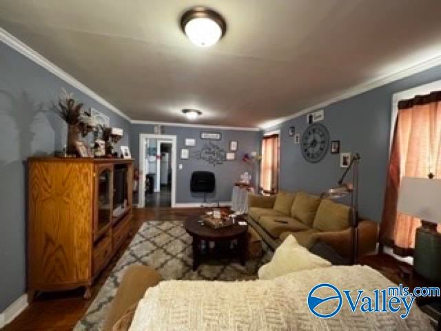 living room with crown molding and dark hardwood / wood-style flooring