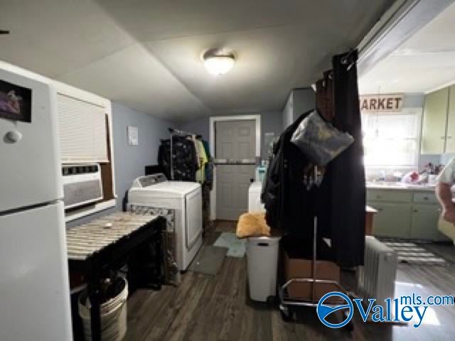 laundry area with dark wood-type flooring, cooling unit, and washer and clothes dryer